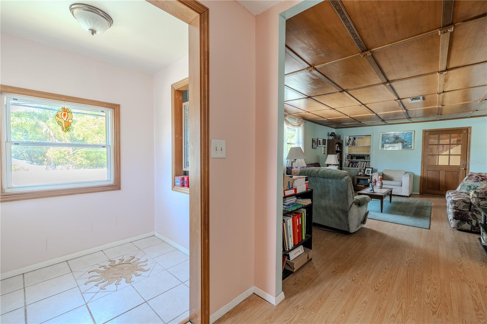 Front entry with decorative tile floor opens to the living room.