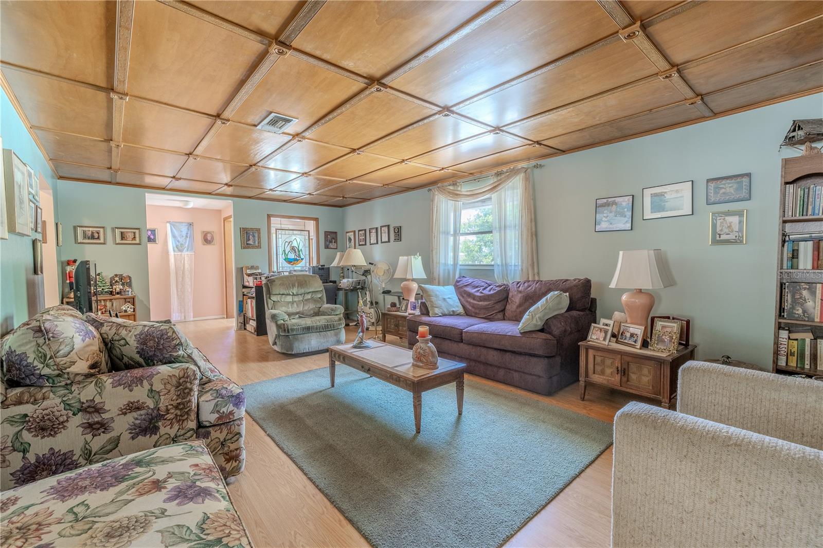 The living room features a custom stained glass window