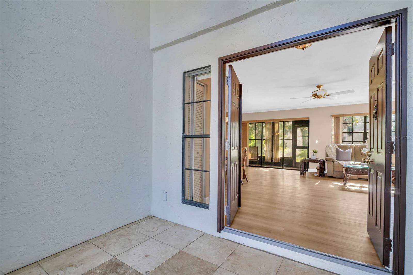 Gracious travertine flooring & double door front entry~