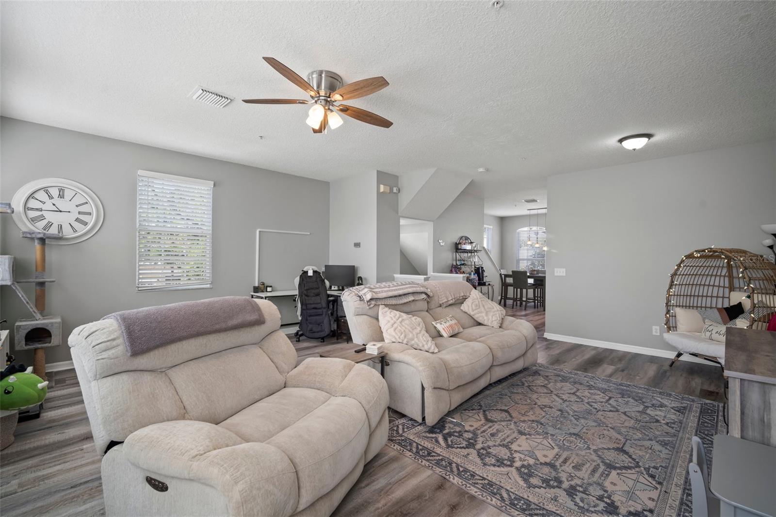 Main level living room with kitchen and eat-in space