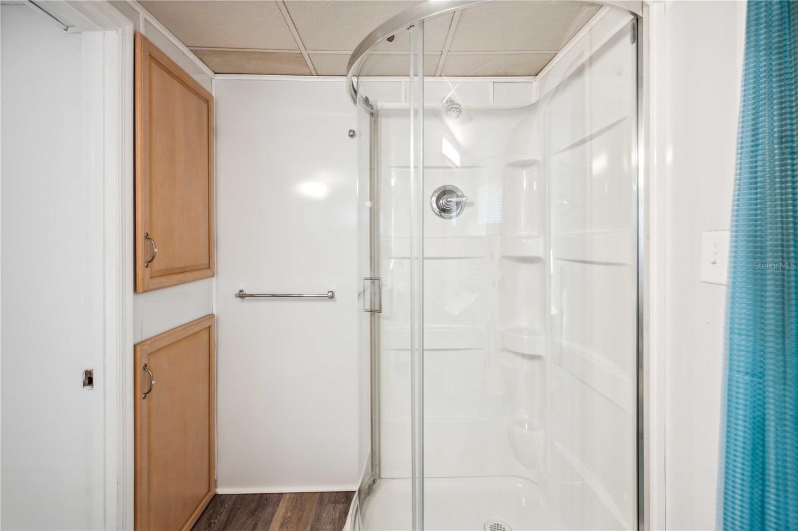 Updated step-in shower, vanity, flooring, and fixtures.