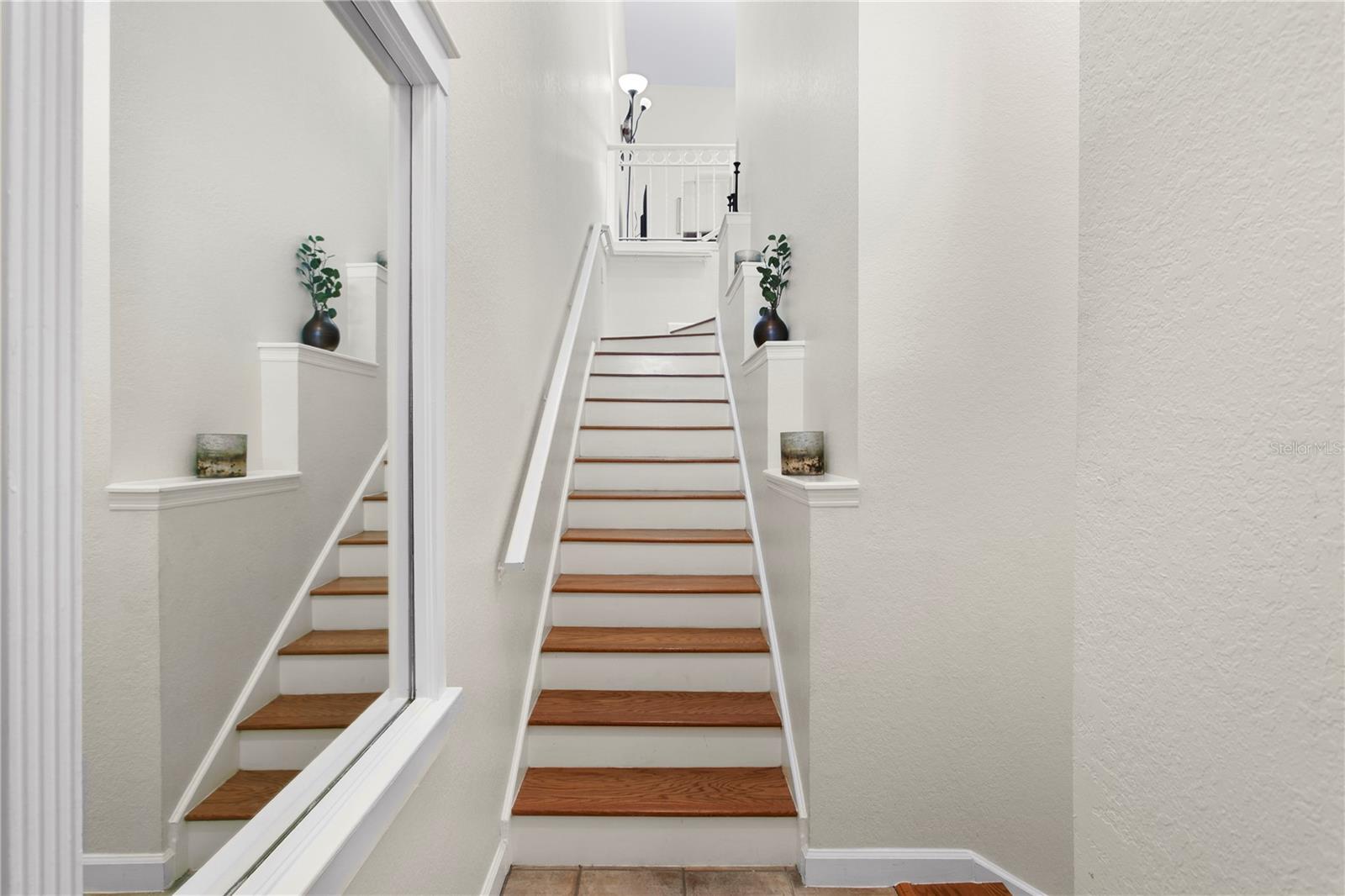 As you arrive you are greeted with soaring 10 + ceilings and stairs that lead you to the open concept living room