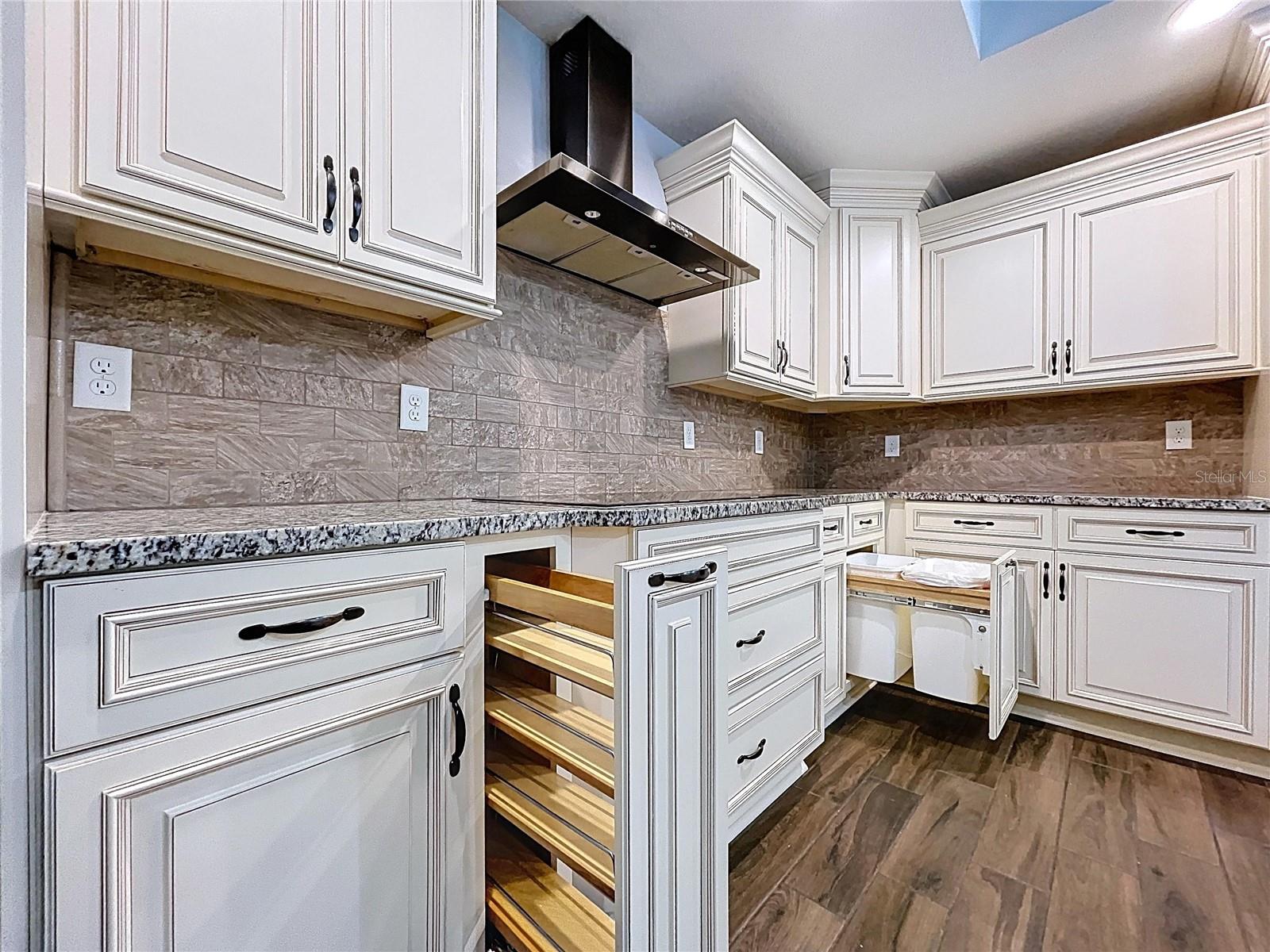 Custom pull-out drawers with spice rack built-ins