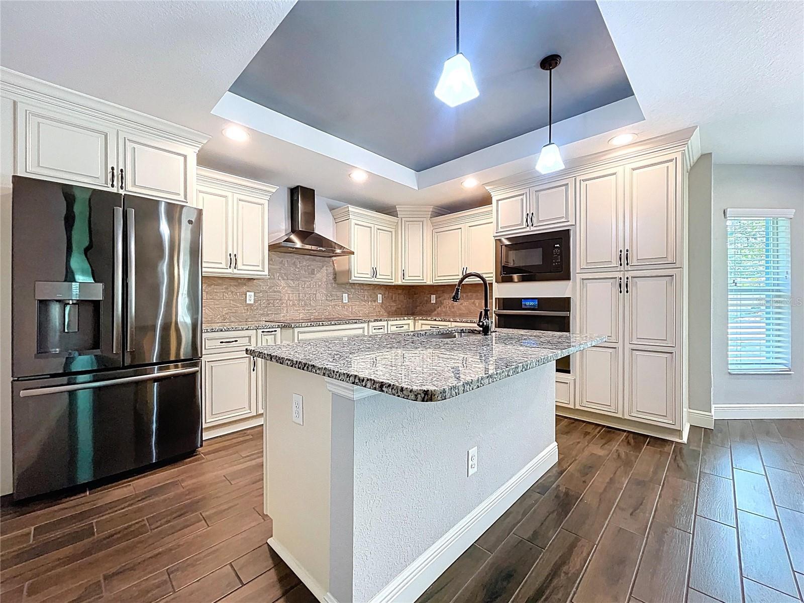 Upgraded kitchen with granite counters.