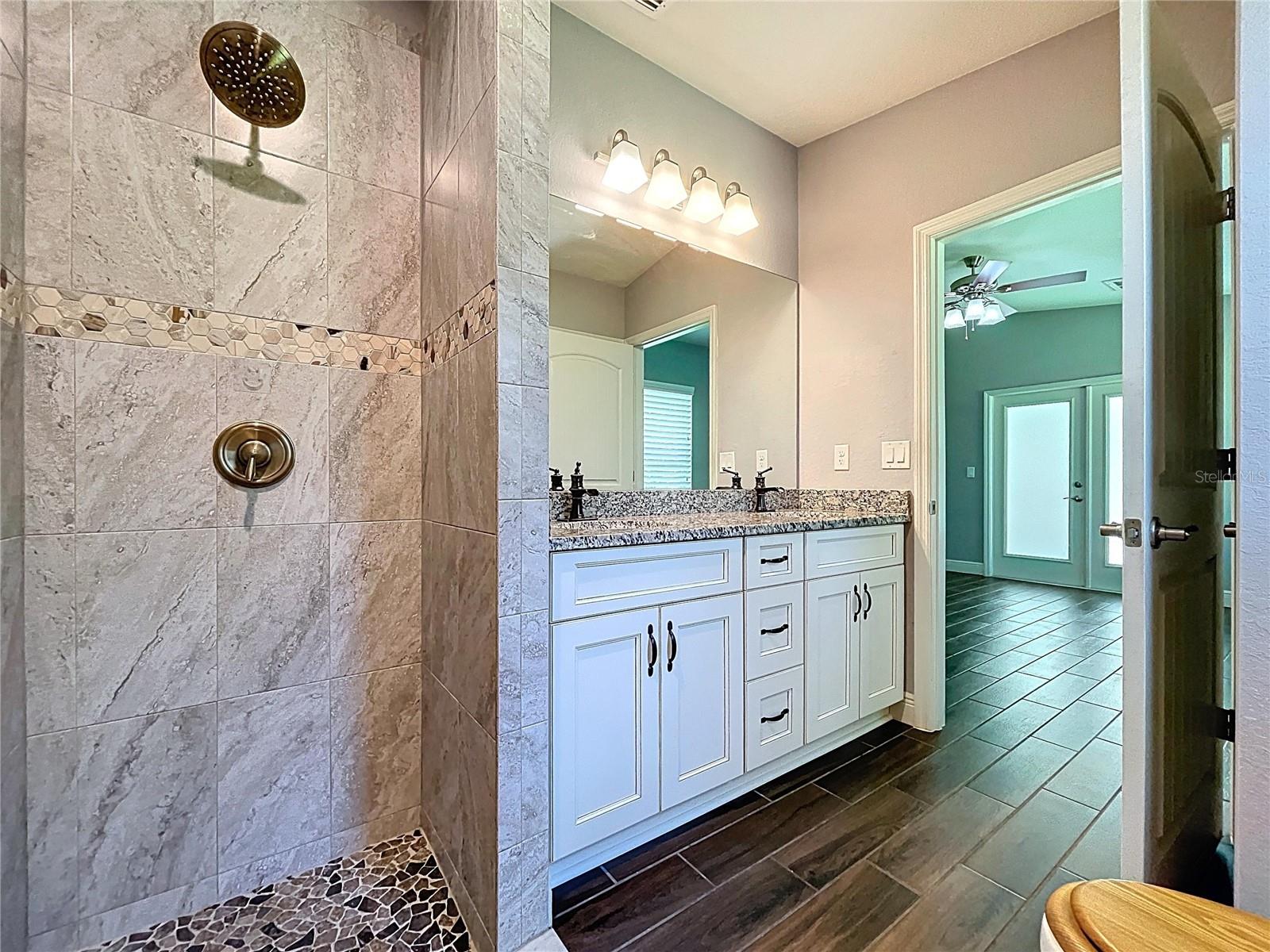 Walk-in shower with custom tile.