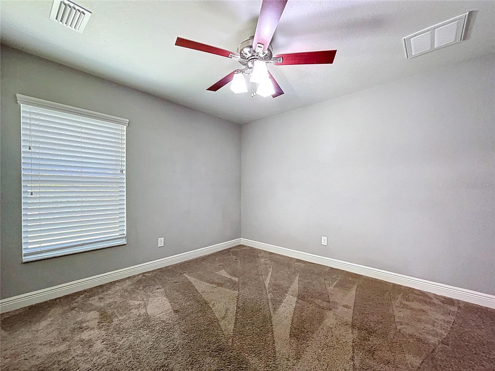 Bedroom two with backyard-facing window.