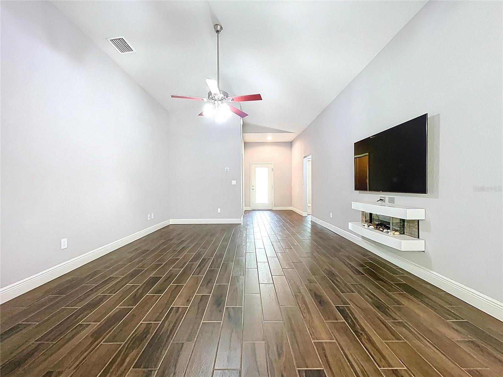 Open concept living area with high ceilings.
