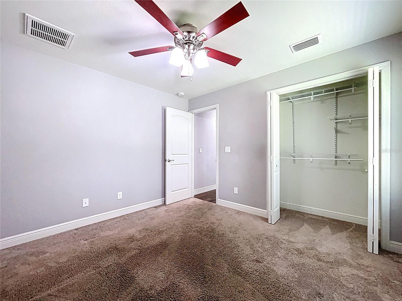 Nice closet and ceiling fan in bedroom two.