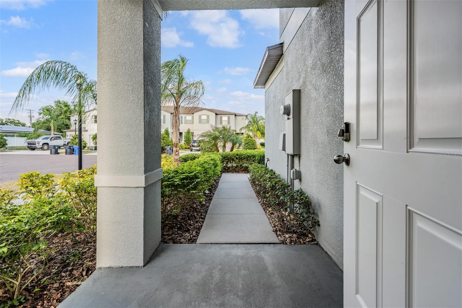 Manicured front walkway with covered front entry
