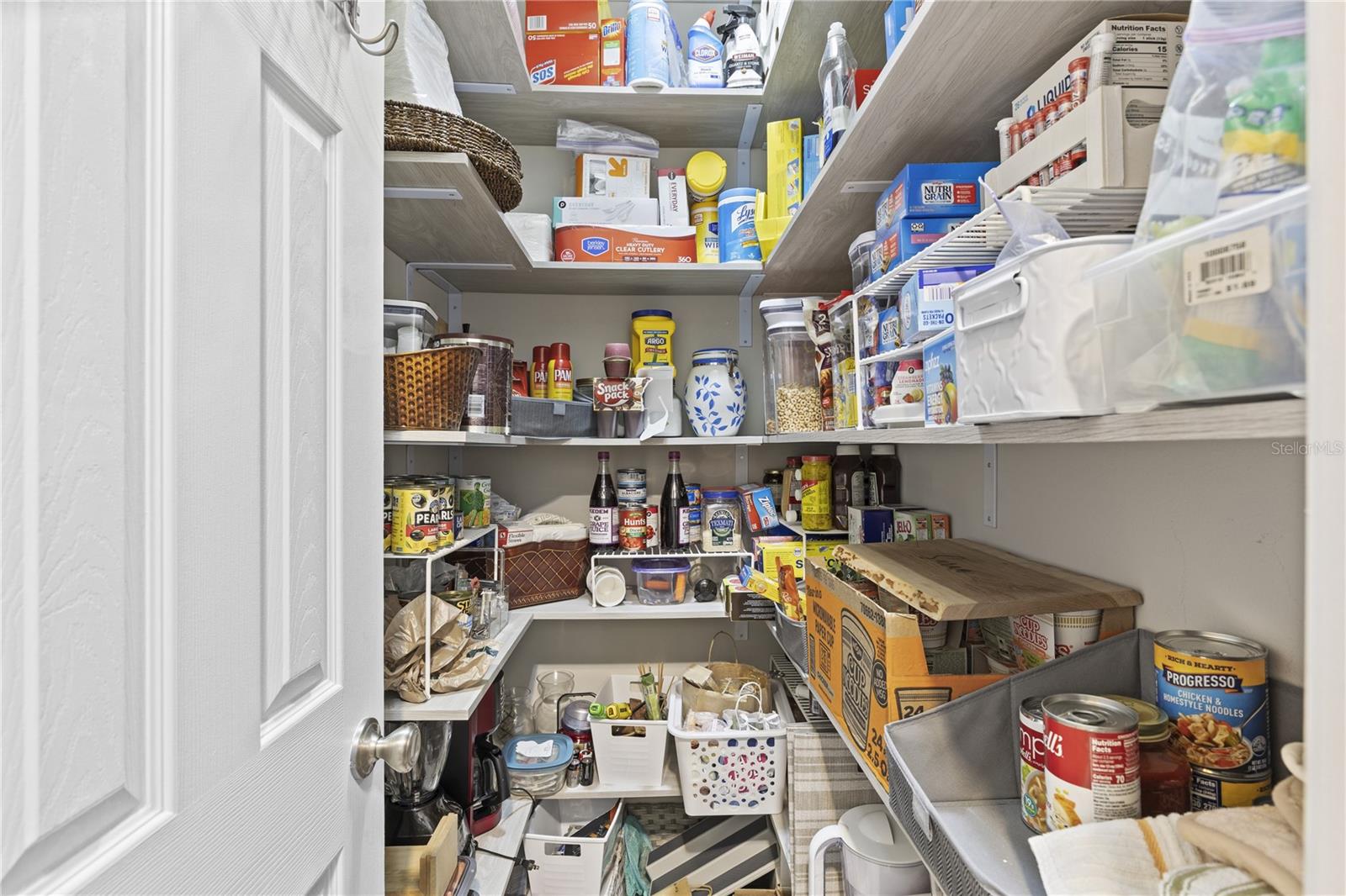 Custom walk in pantry added with wooden shelving