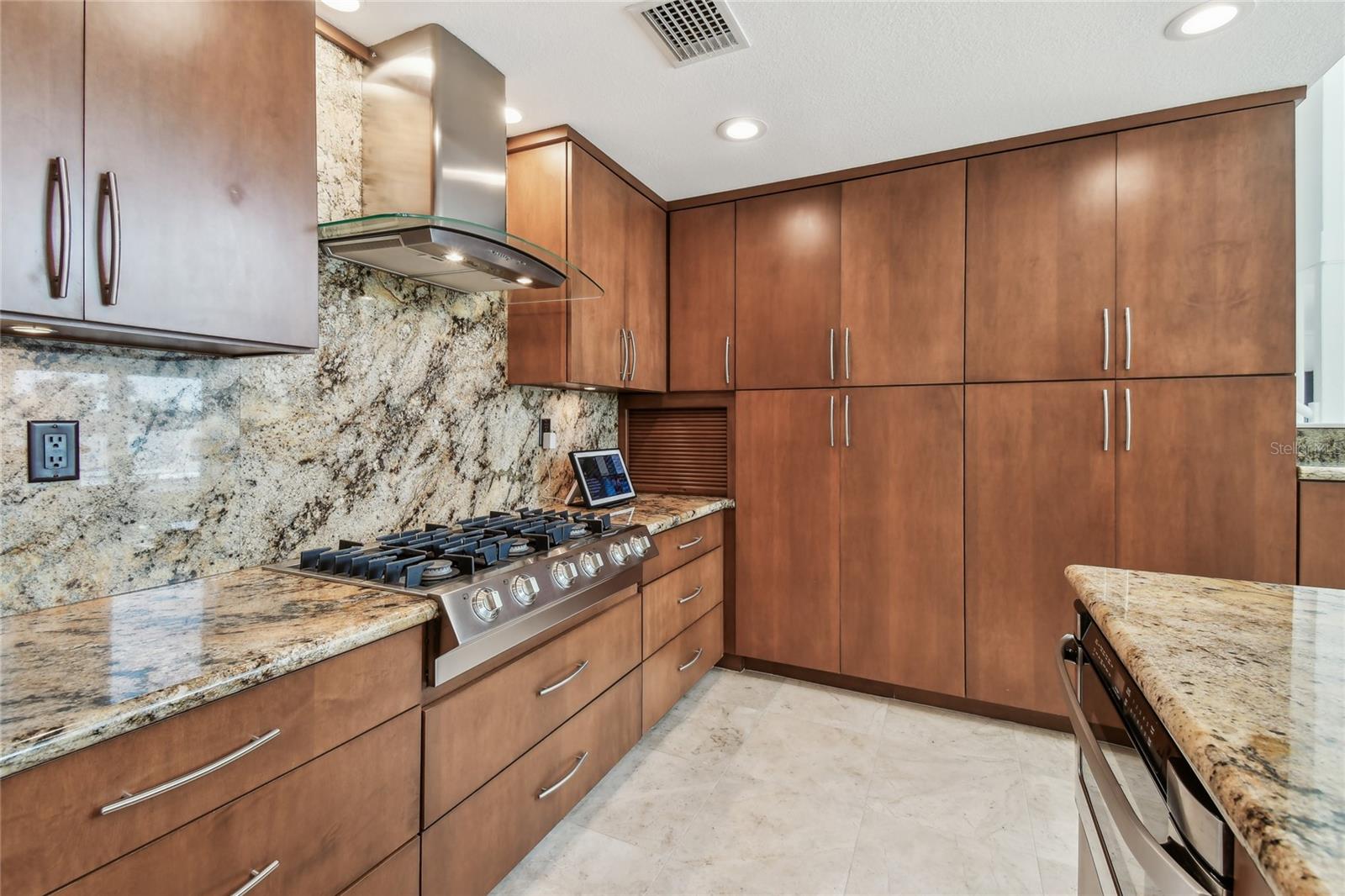 Gas cooktoop, Granite countertops, Generous cabinets and storage