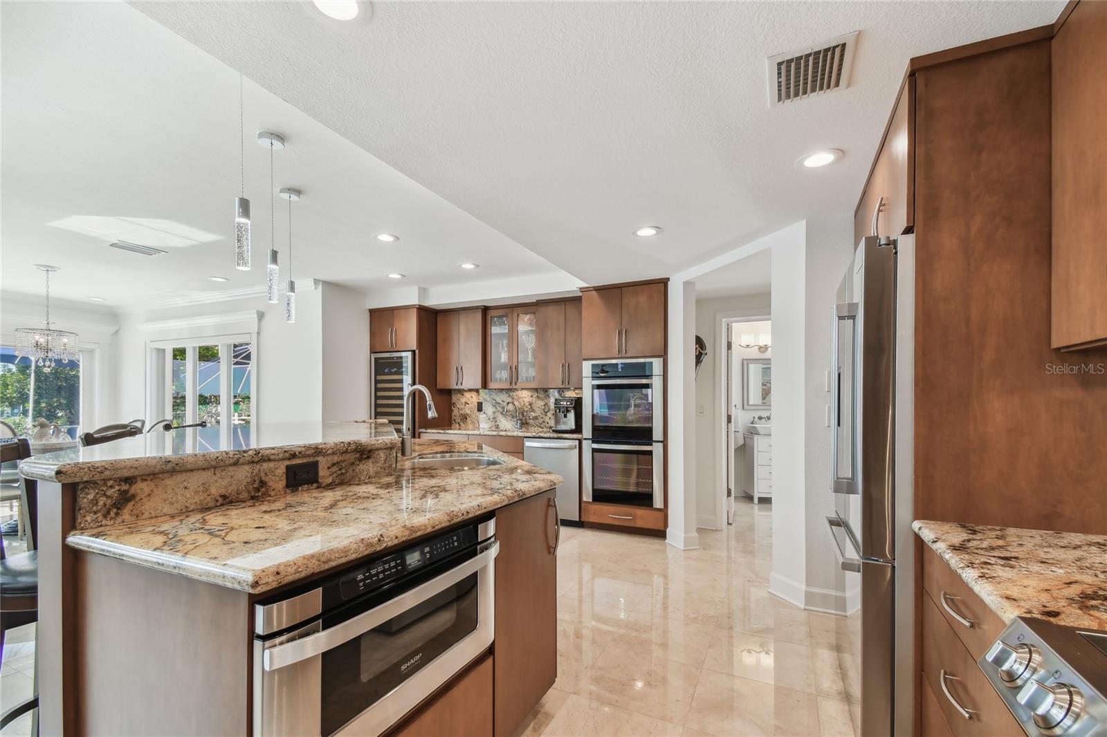 Open concept Kitchen Dining, entranceway into pool bath, laundry room