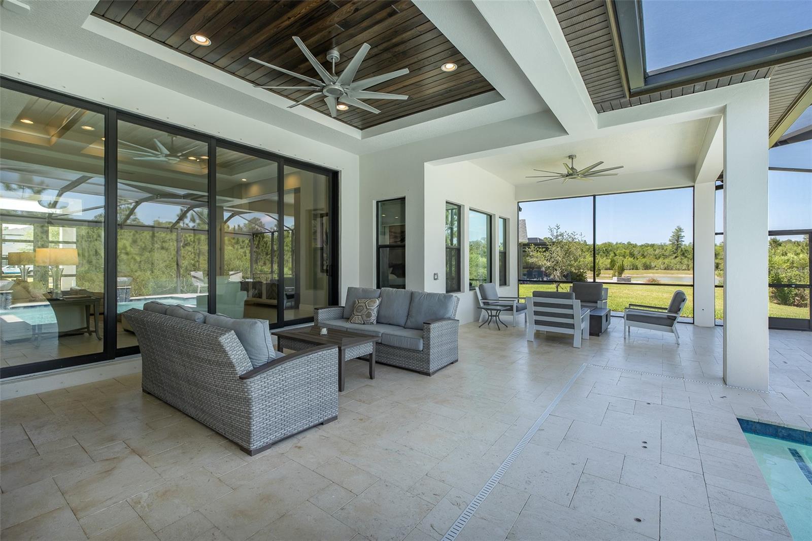Expansive Screened lanai w/custom wood ceilings & travertine!