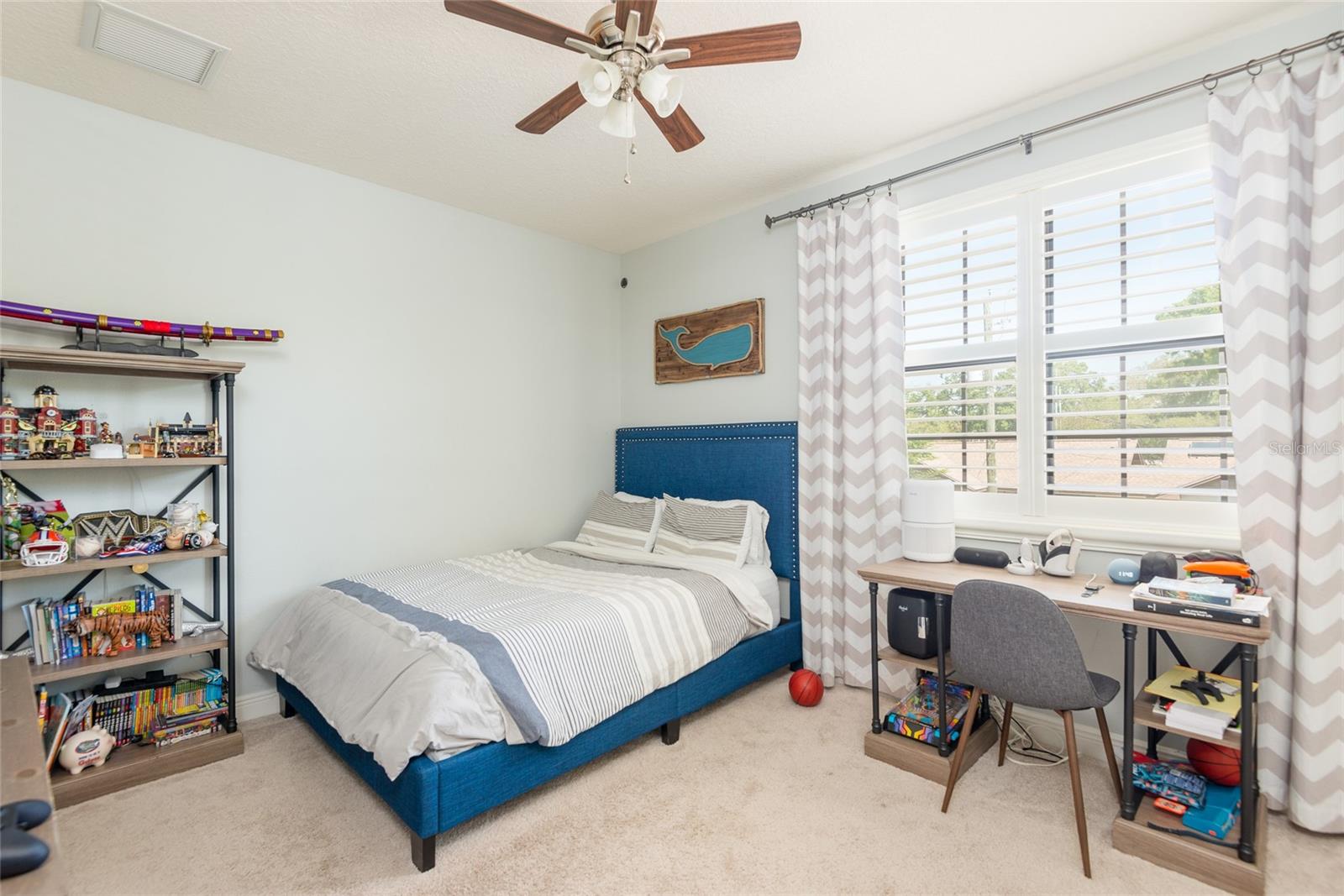 Bedroom 2 with ensuite bathroom, custom closet and shutters.