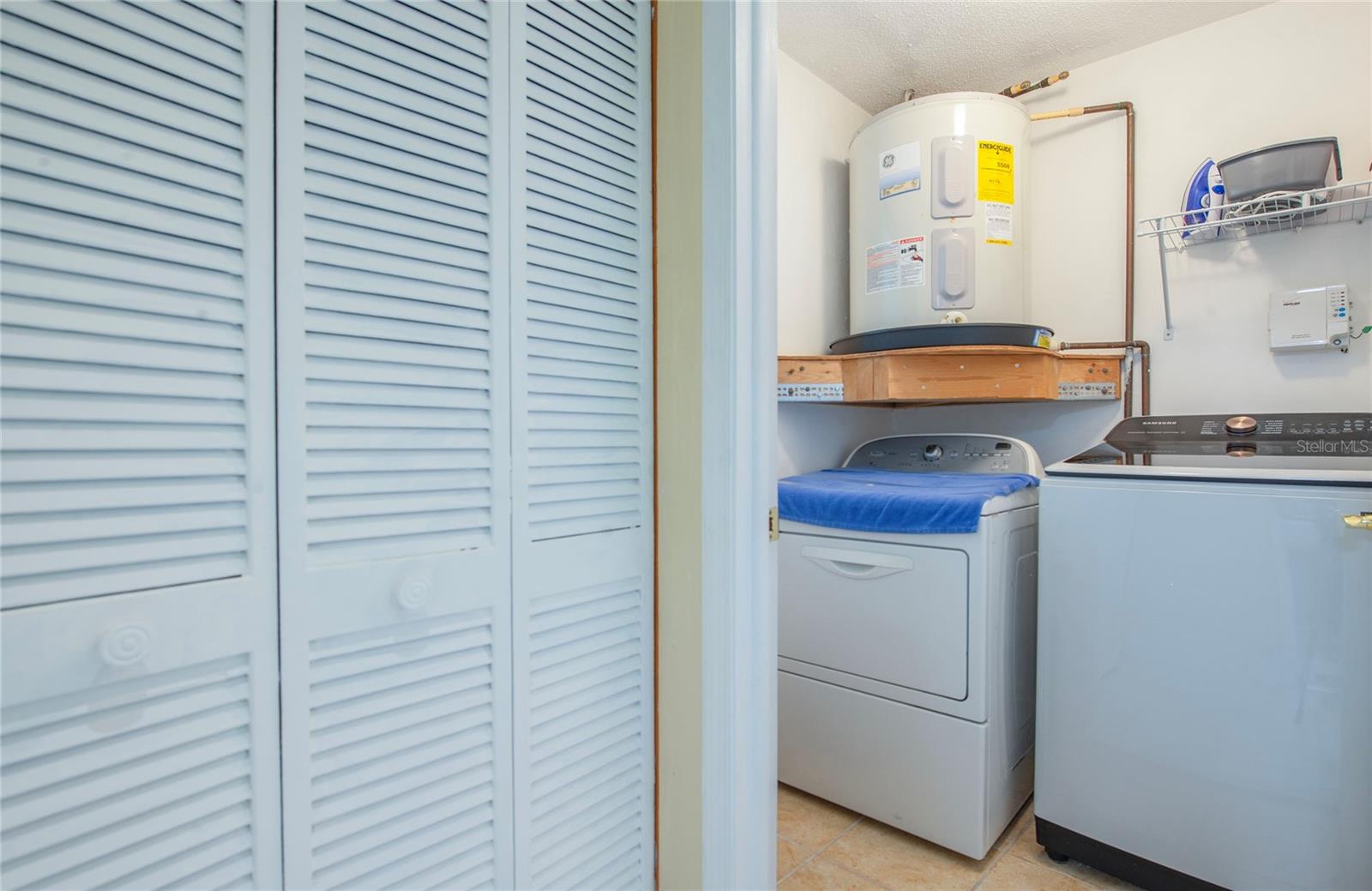 inside laundry with pantry closet. washer and dryer included