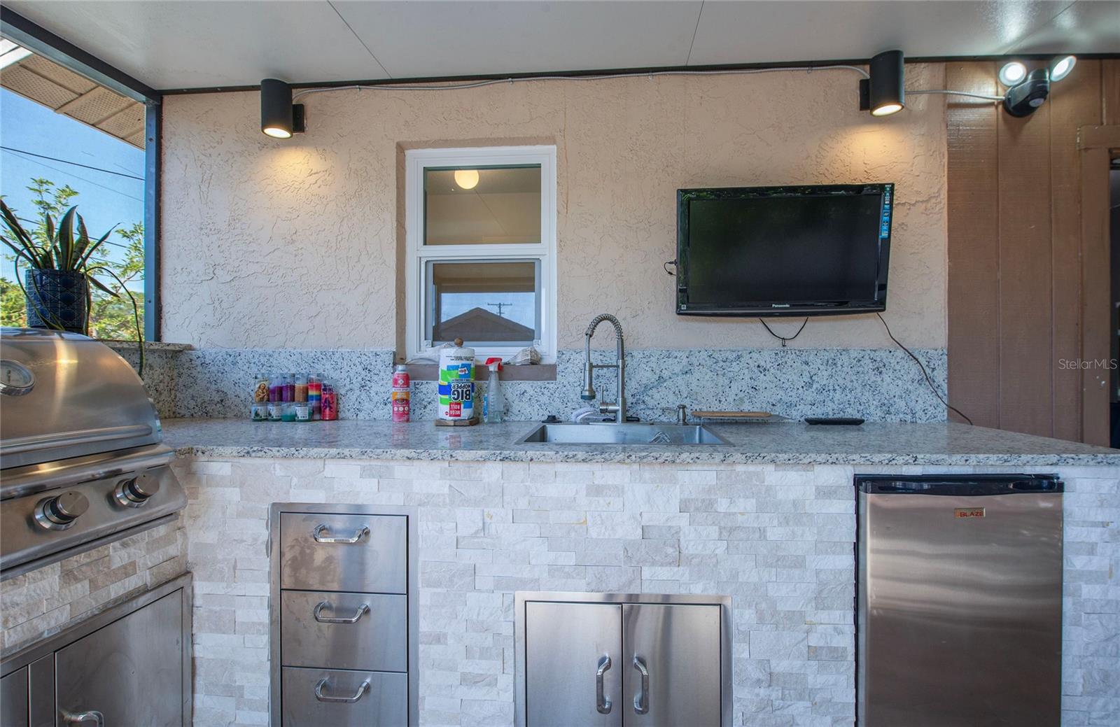 refrigerator, grill sink and lots of granite counter top space