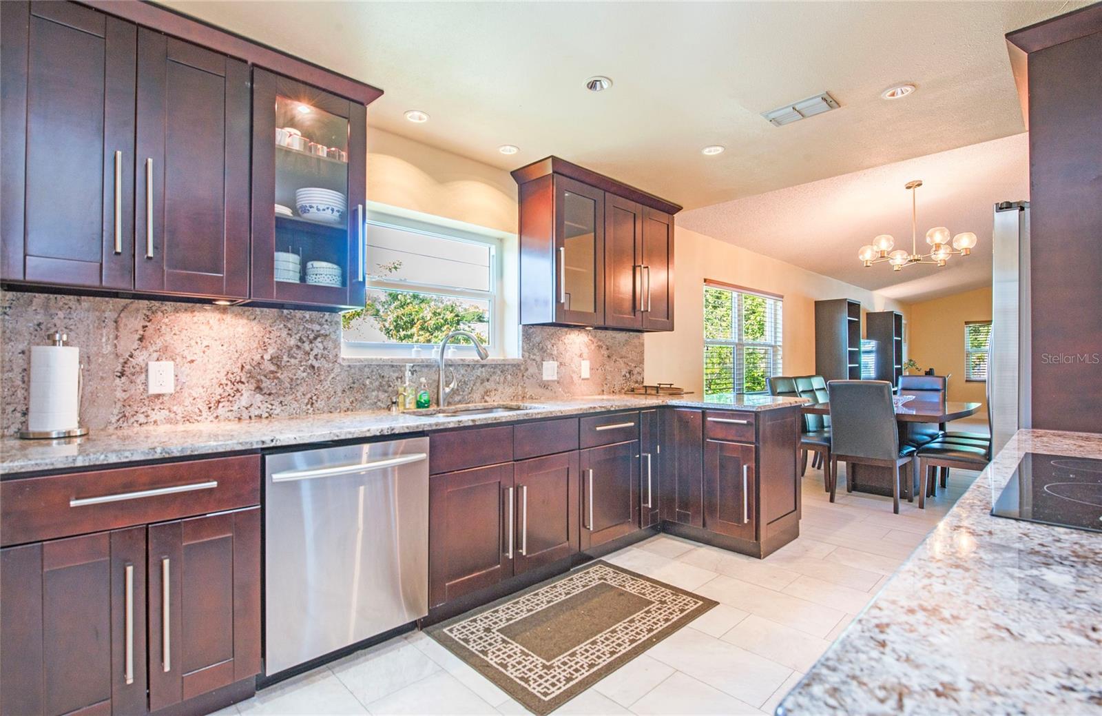 wood cabinets, granite counter tops and backsplash rest on marble floors