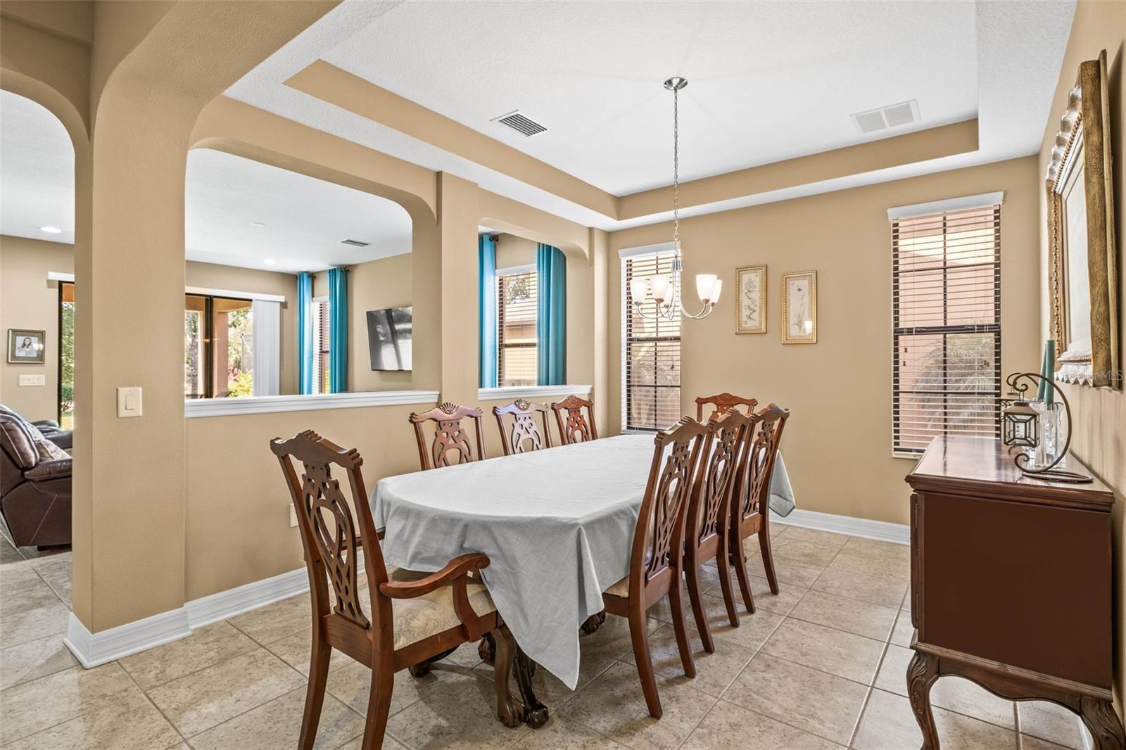 Formal dining area with tray ceiling fits 10+ with storage space!