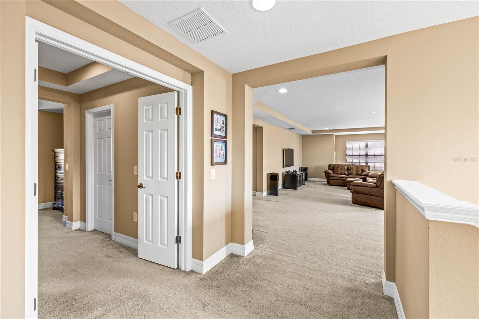Travel upstairs to the primary suite and HUGE media/flex loft.