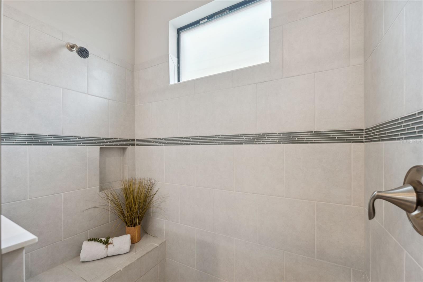 Natural light, premium tile in the shower