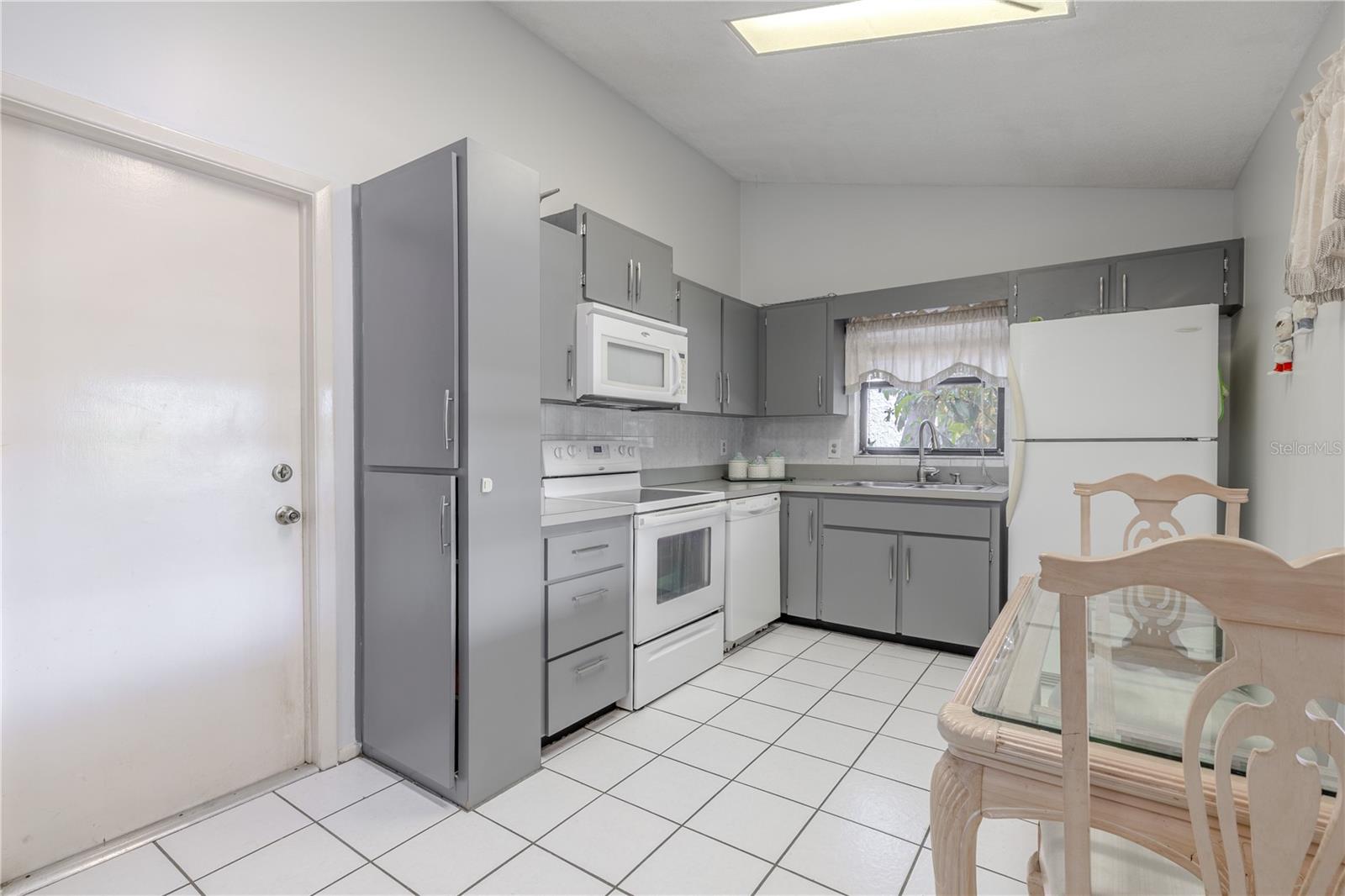 The kitchen has a door to access the garage.