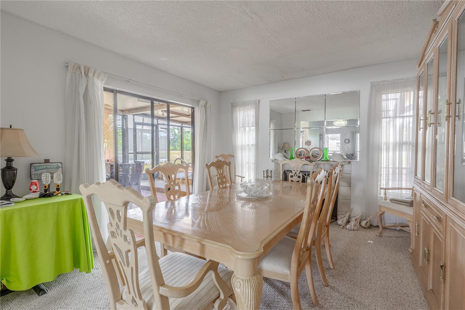The family room features a wood burning fireplace and sliding glass doors to the lanai.