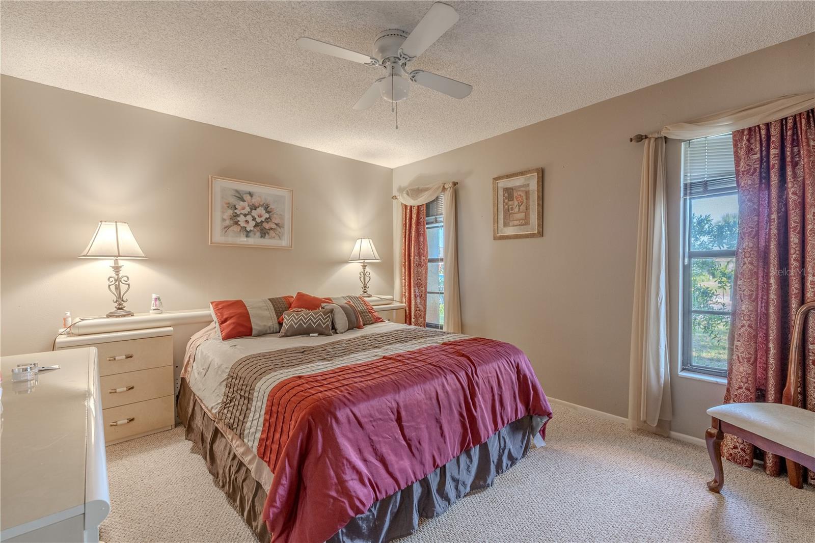Bedroom 3 features a monochromatic color scheme (carpet and walls) and a ceiling fan with light kit.