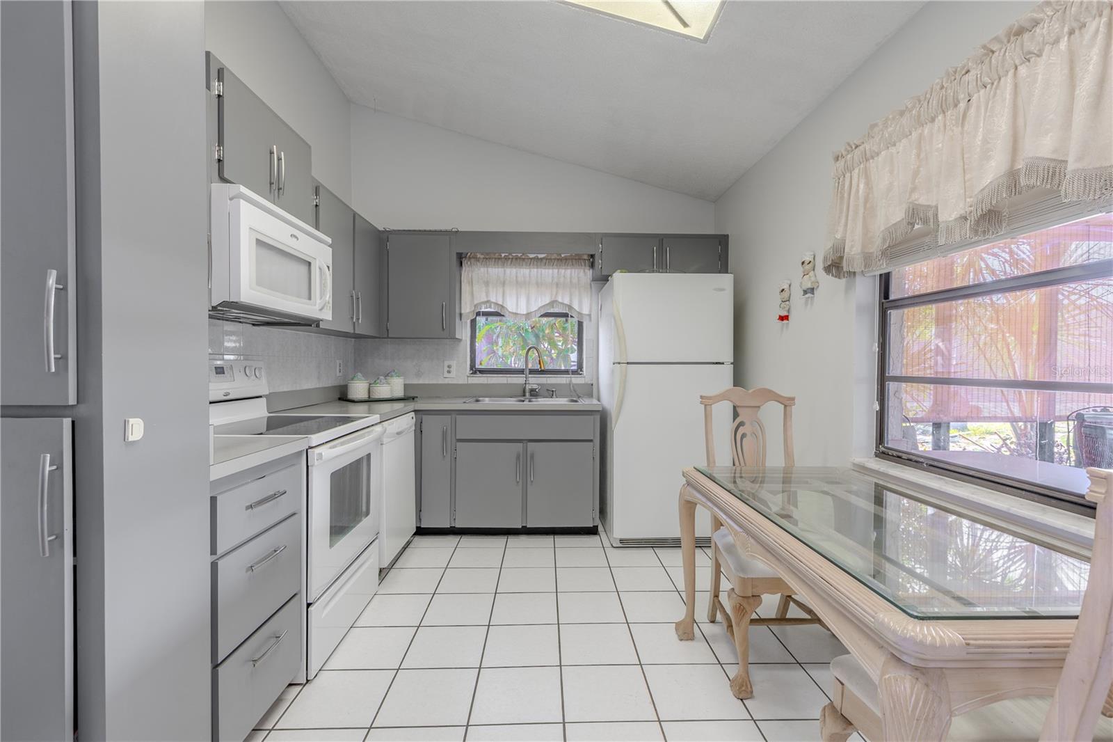 The kitchen has a closet pantry and room for your breakfast table with a view of the screened in lanai and back yard.