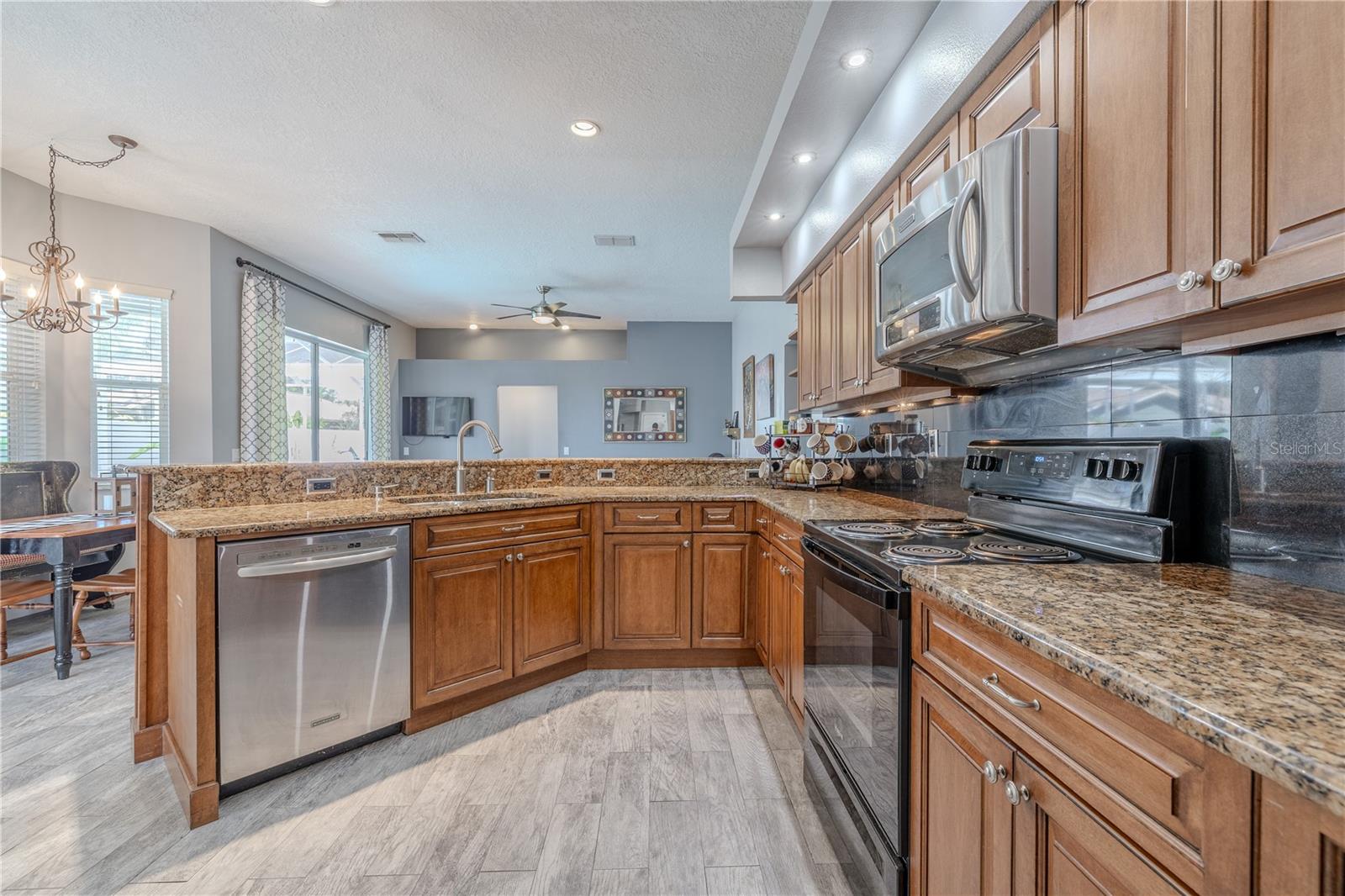 The kitchen features a full suite of appliances including a dishwasher, range,microwave and refrigerator.
