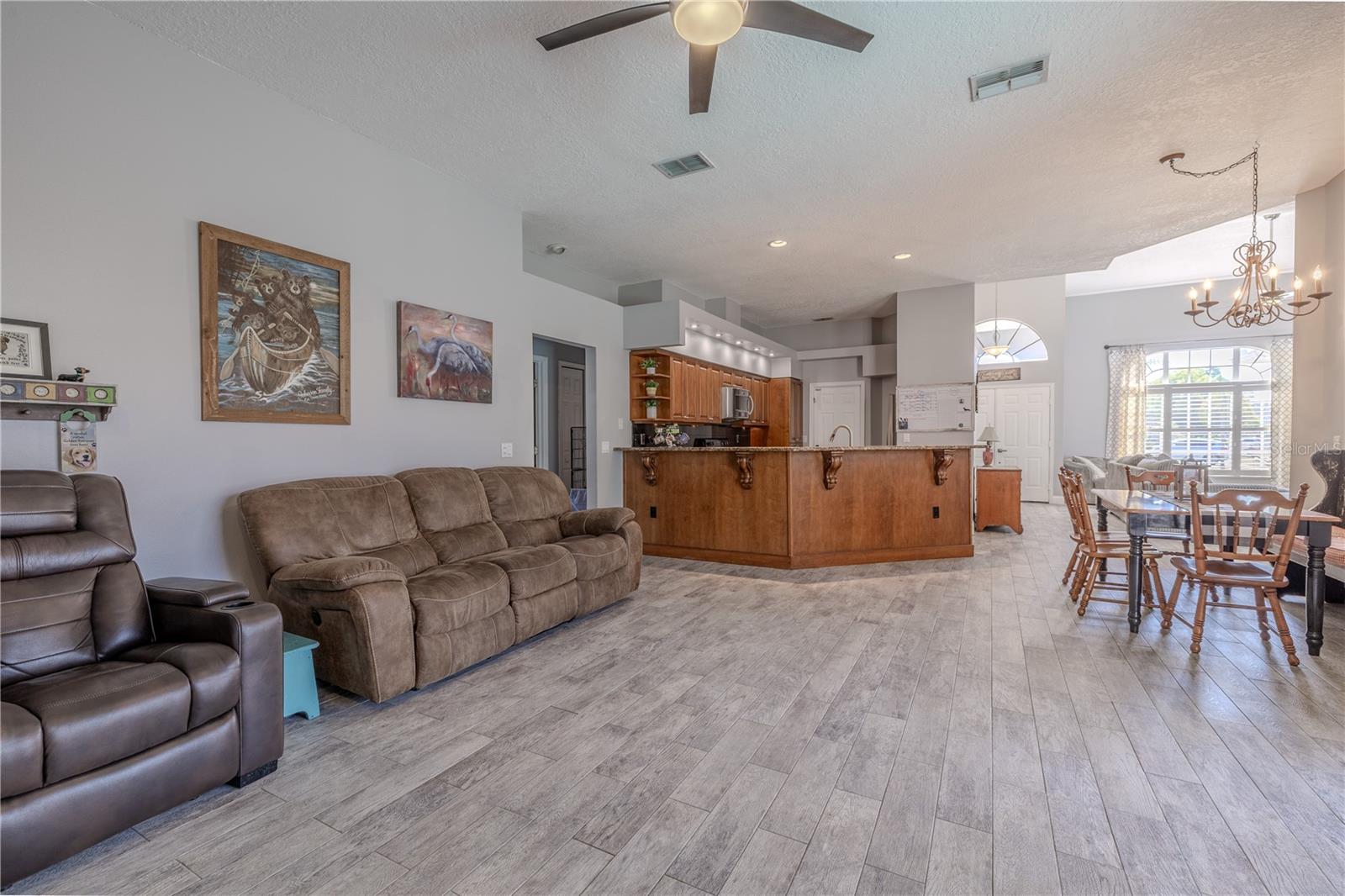 The family room with view of the kitchen and breakfast nook.