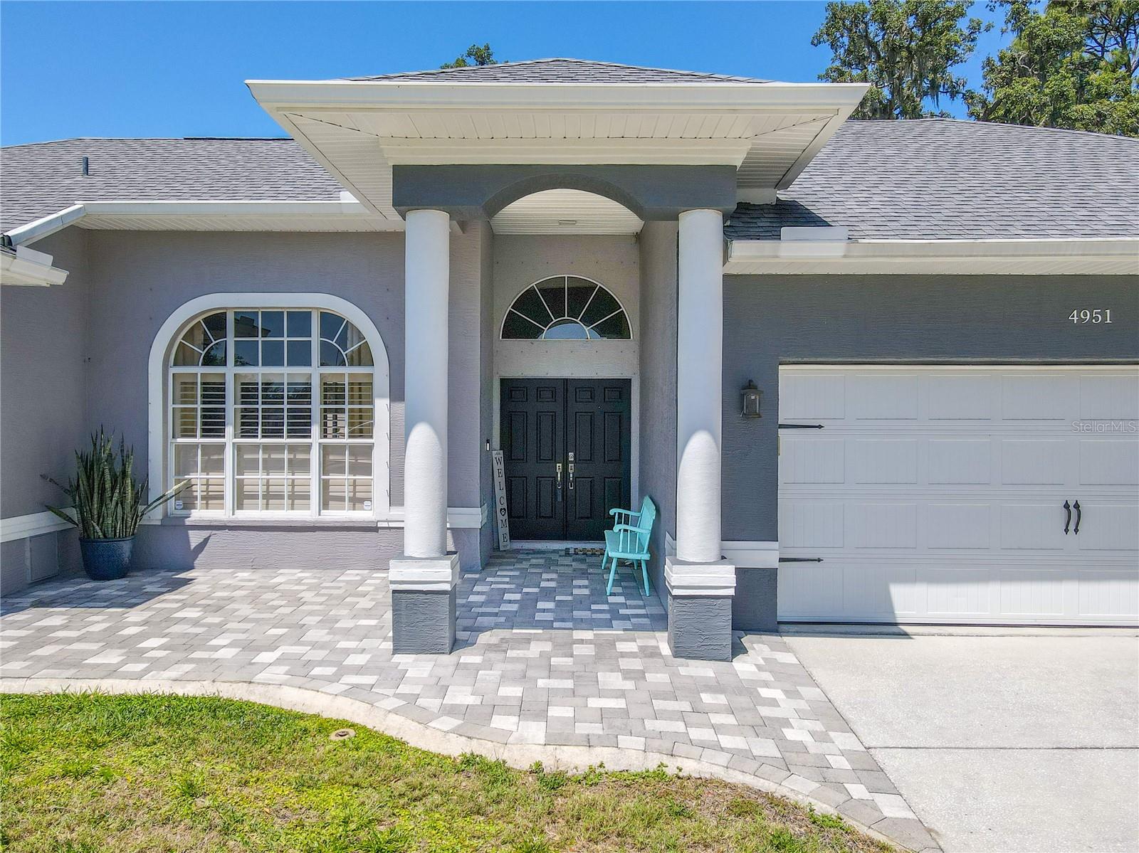 Beautiful front porch and covered entryway with stone pavers.