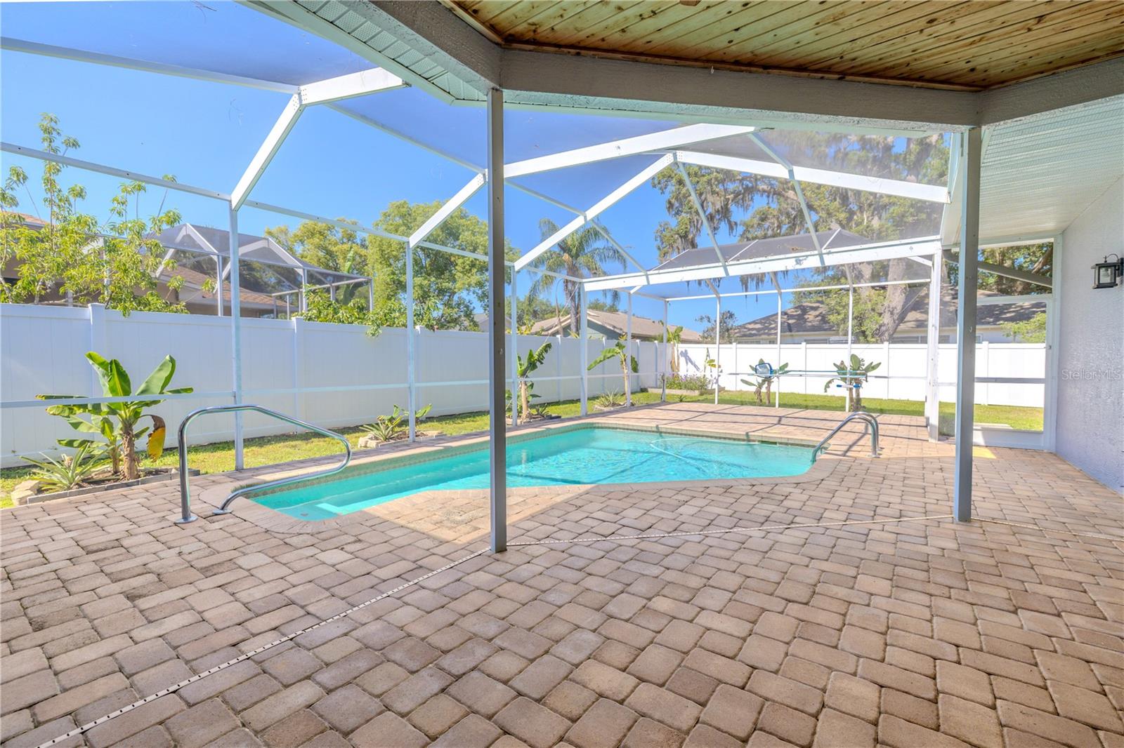 Pool and lanai with private fenced in backyard