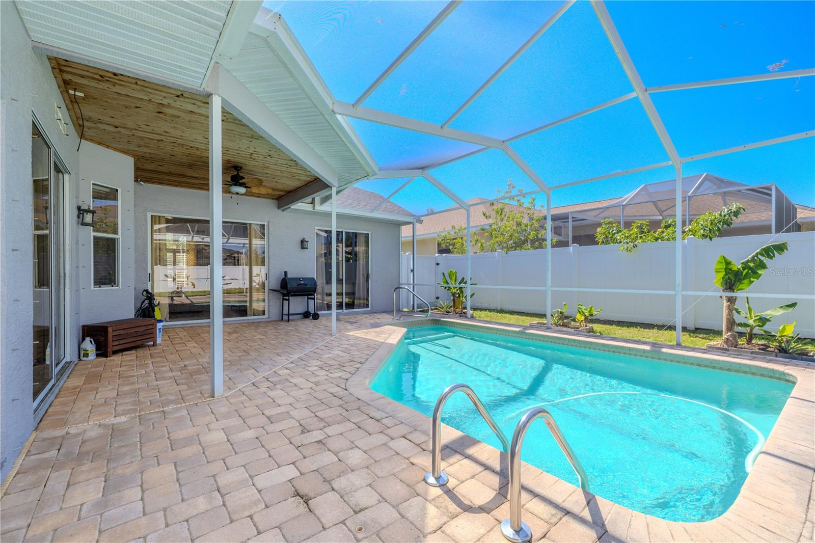Pool and lanai with private fenced in backyard