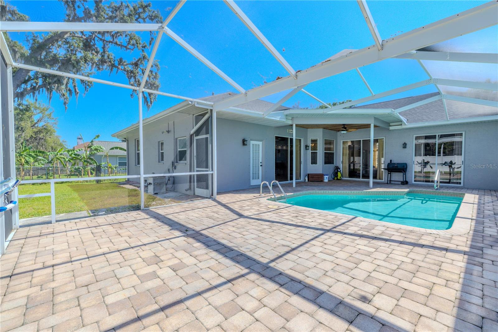 Pool and lanai with private fenced in backyard