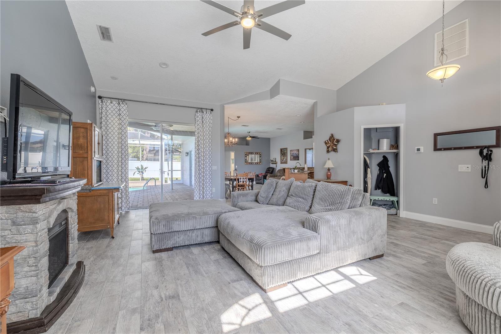 The living room has sliding glass doors that open to the screened in lanai.