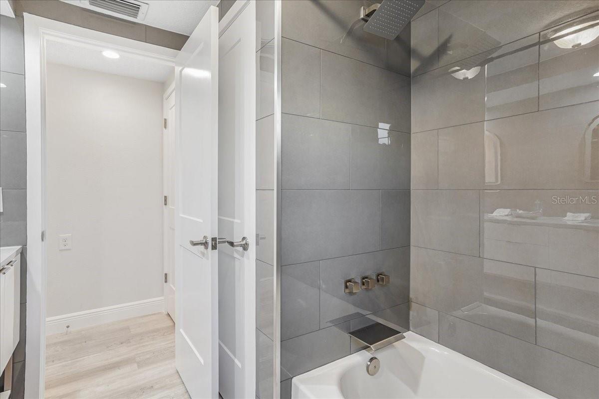 luxury level fixtures and tile surround this tub