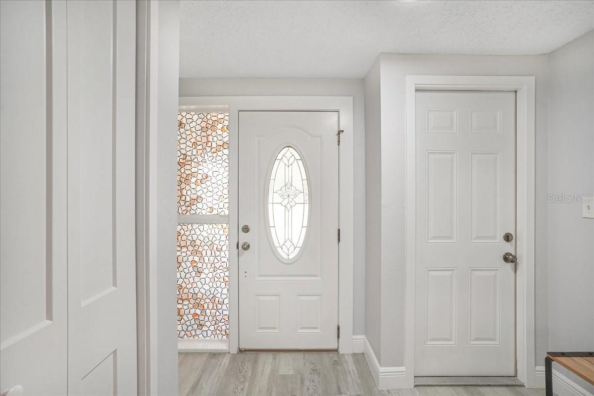 front door and door to garage on right