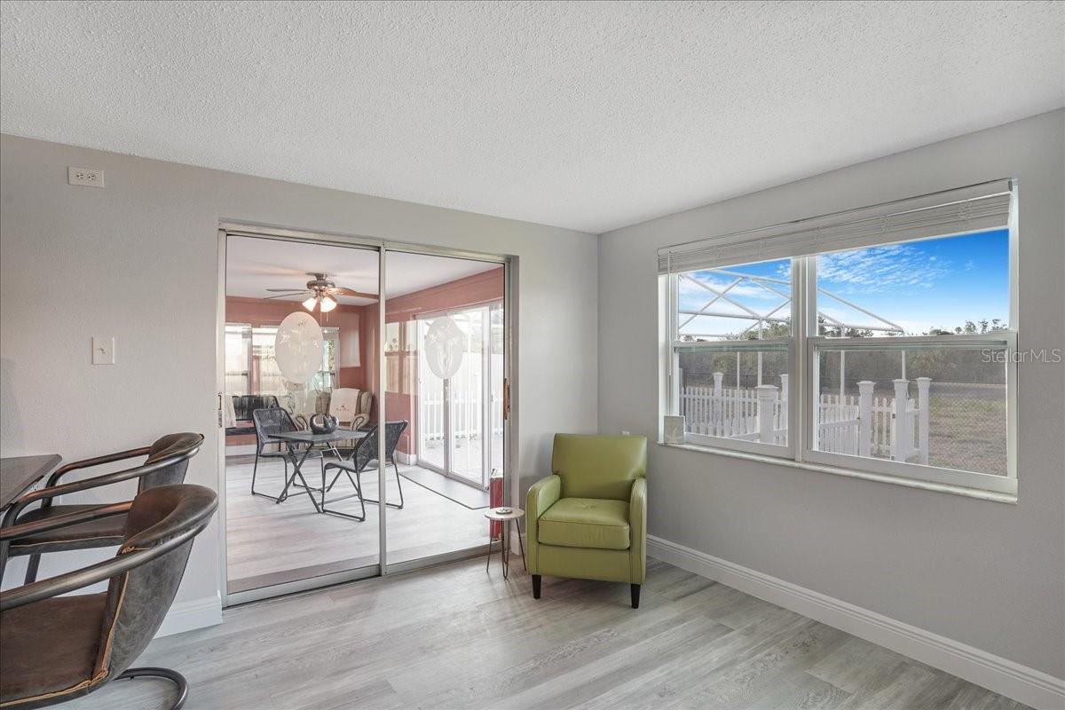 sliders off dining area to enclosed porch