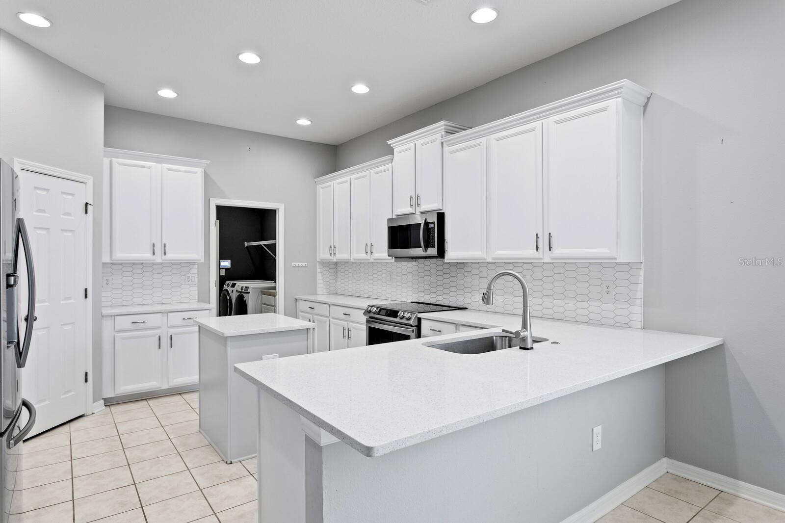 There's a large breakfast bar in the kitchen