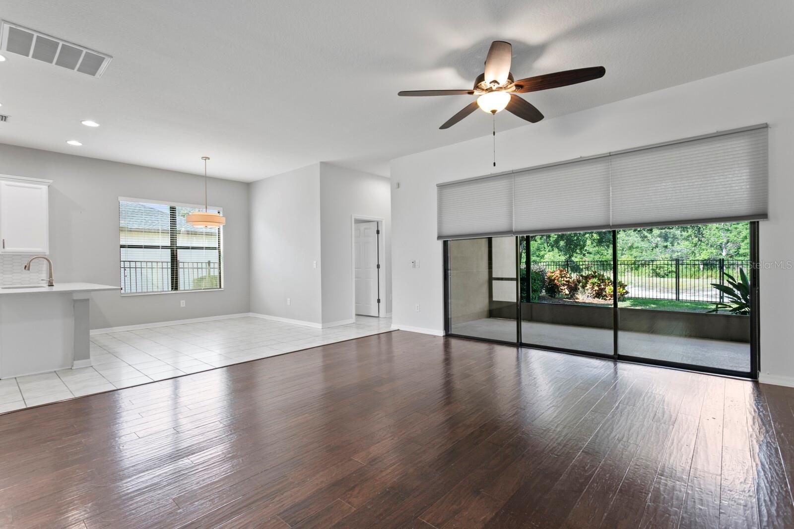 The family room has triple oversized sliding glass doors out to the screen-enclosed lanai