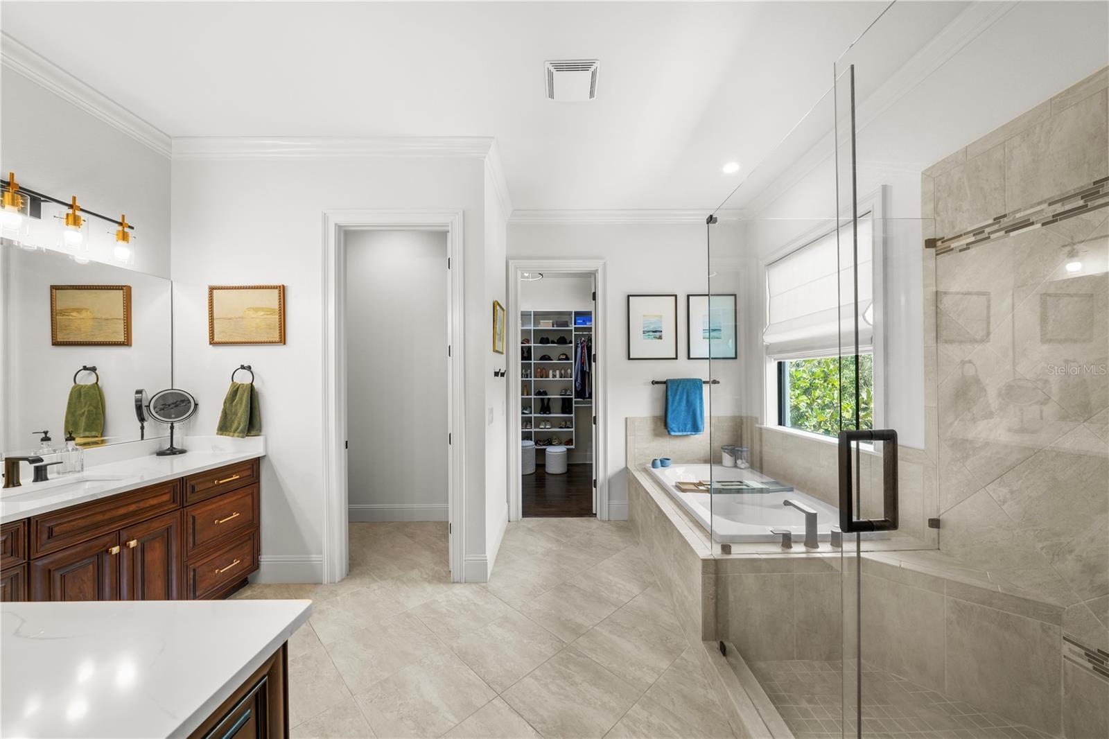 Primary bathroom features soaking tub, walk in shower and