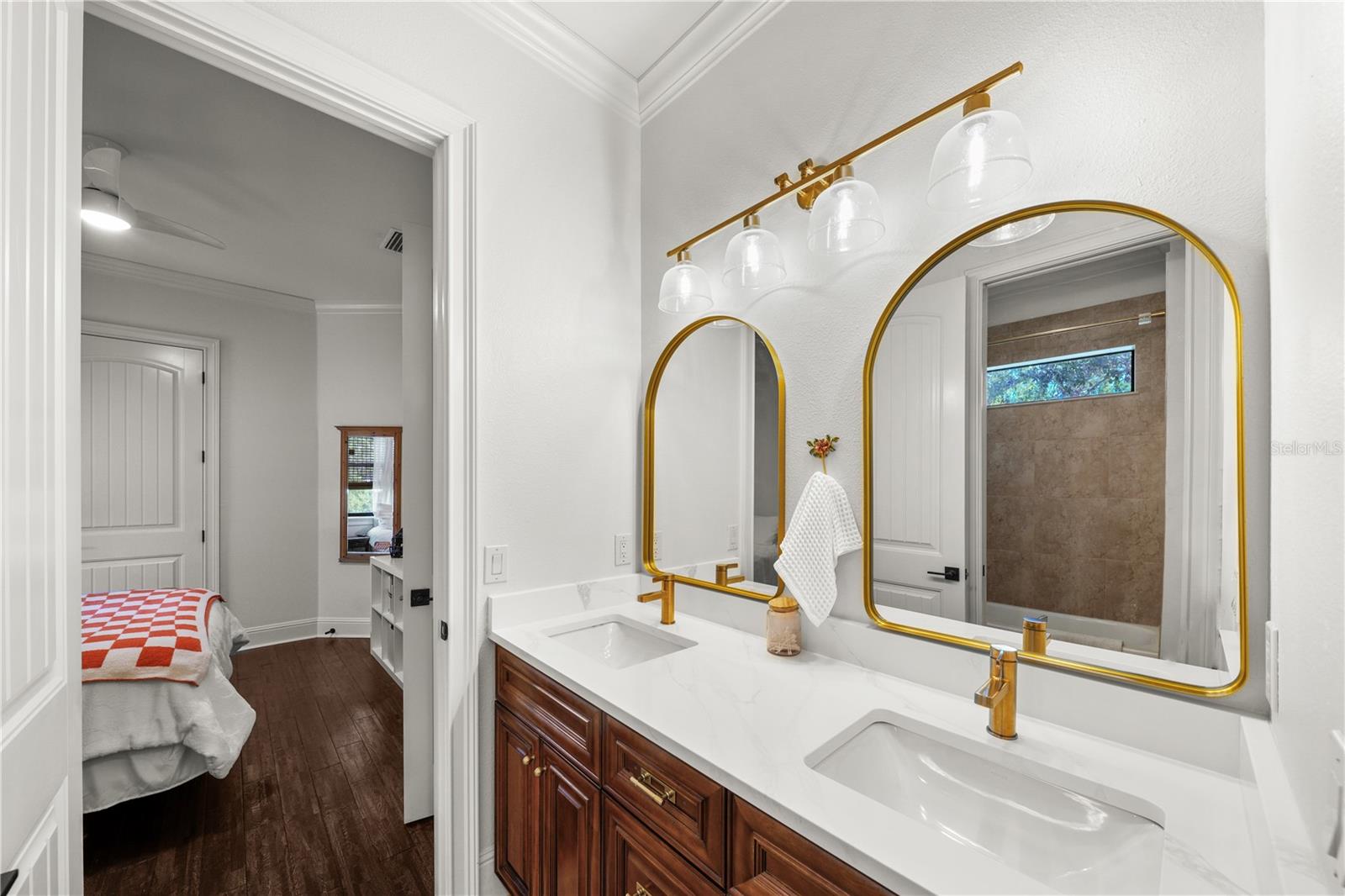 With a dual sink vanity and separate shower area