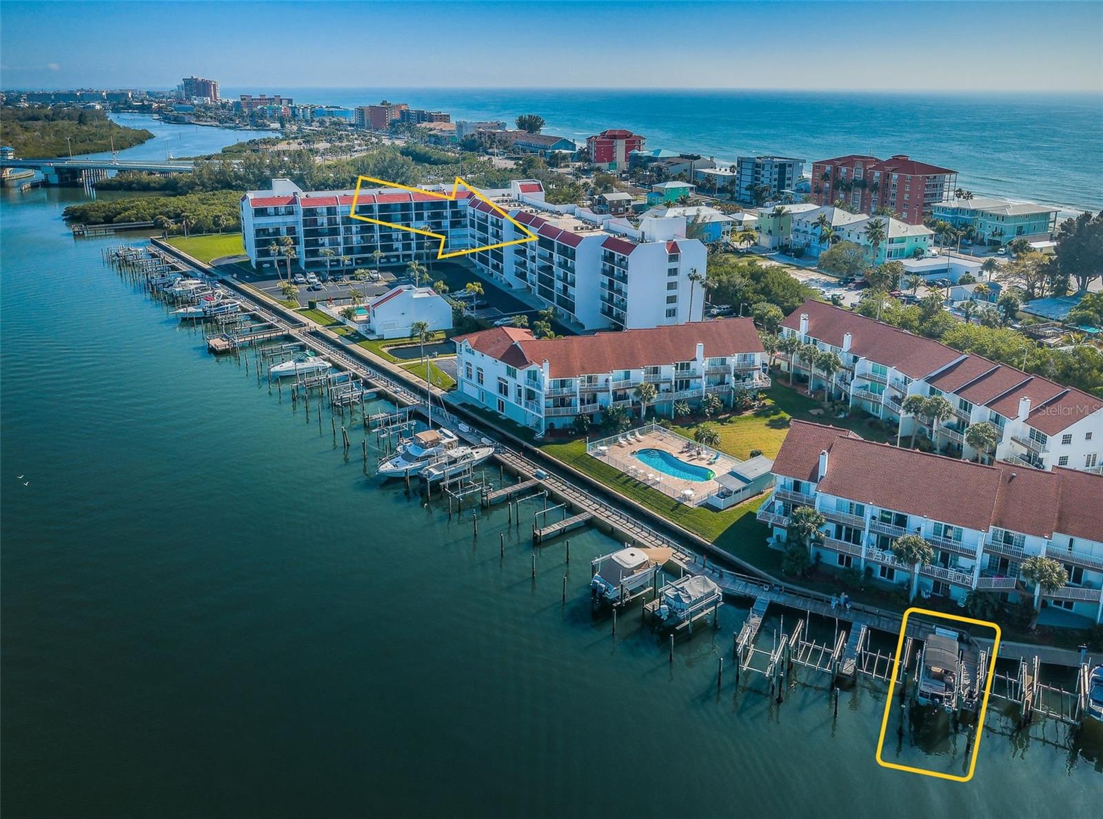 TOP FLOOR with water views from every vantage point! A private boat slip with a lift, hurricane shutters, impact windows west side, and so much more can be yours at this breathtaking unit, located steps from the gulf beaches!