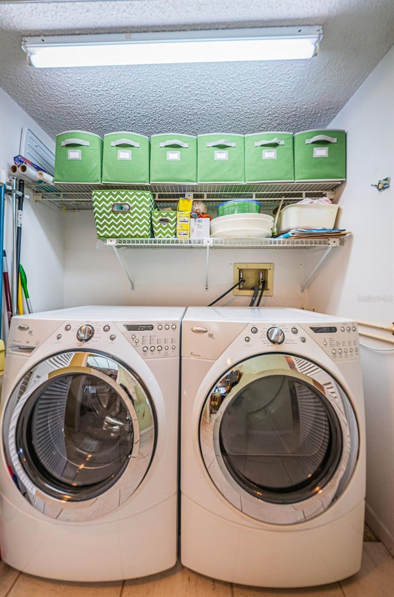 Full size washer and dryer in laundry closet.