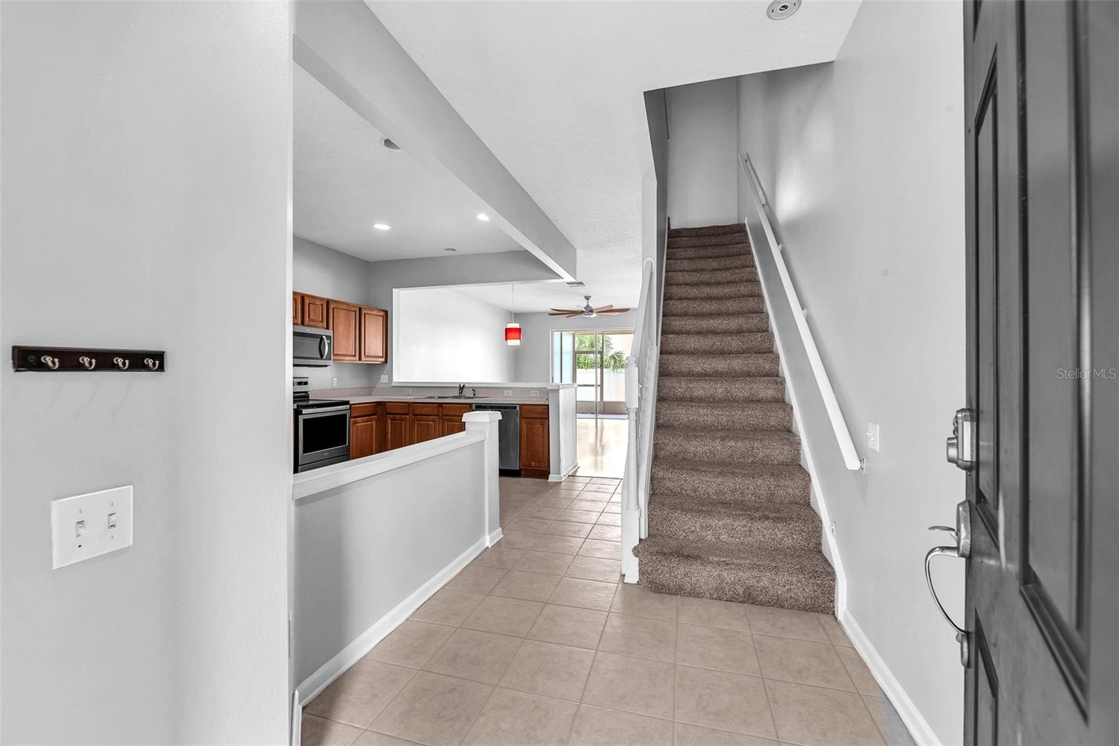 Stepping inside, you are greeted with a two-story foyer and an open floor plan.