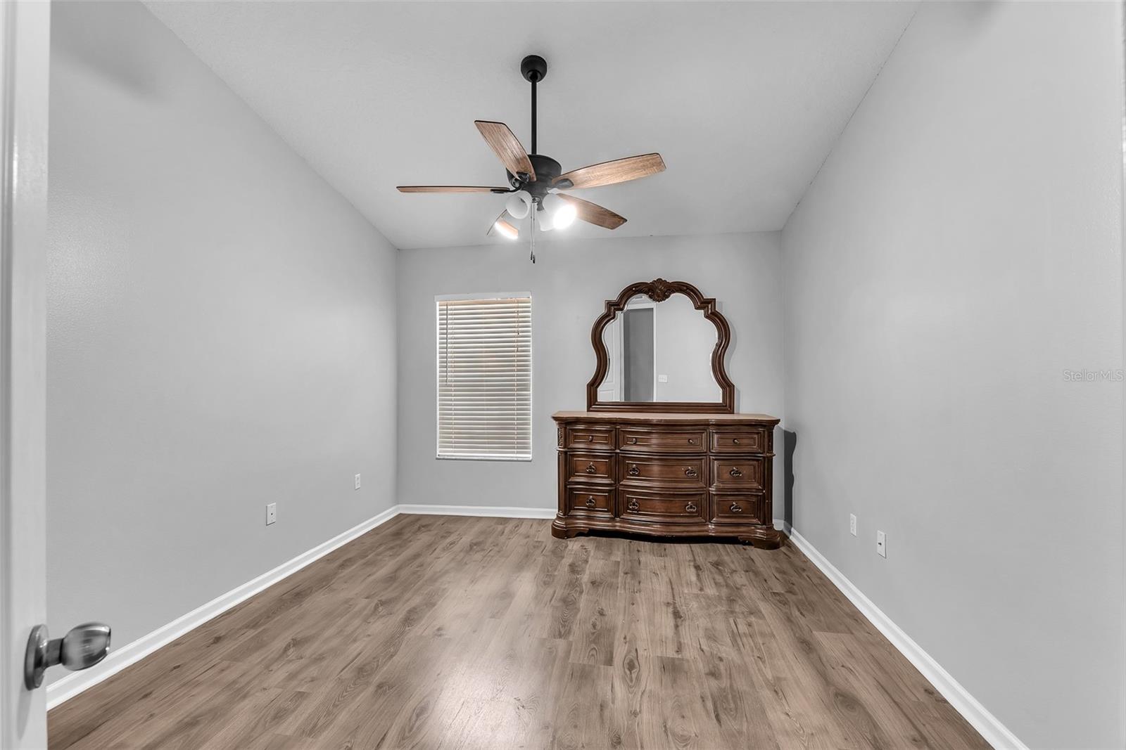 Secondary bedroom #3 offers cathedral ceilings, space and durable laminate flooring and shares a full bathroom.