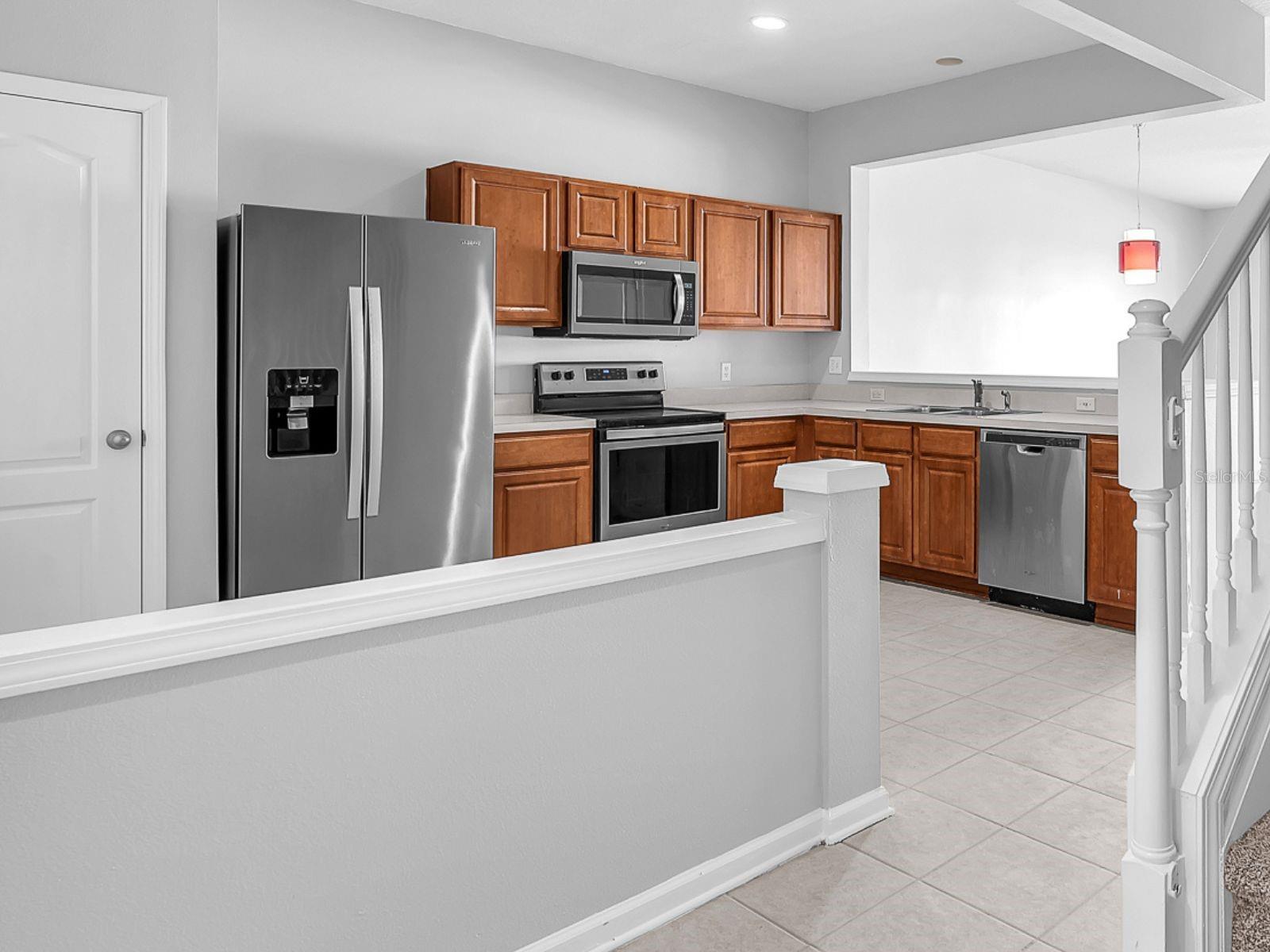 The kitchen features recently upgraded stainless steel appliances, breakfast bar and a pantry for extra storage.