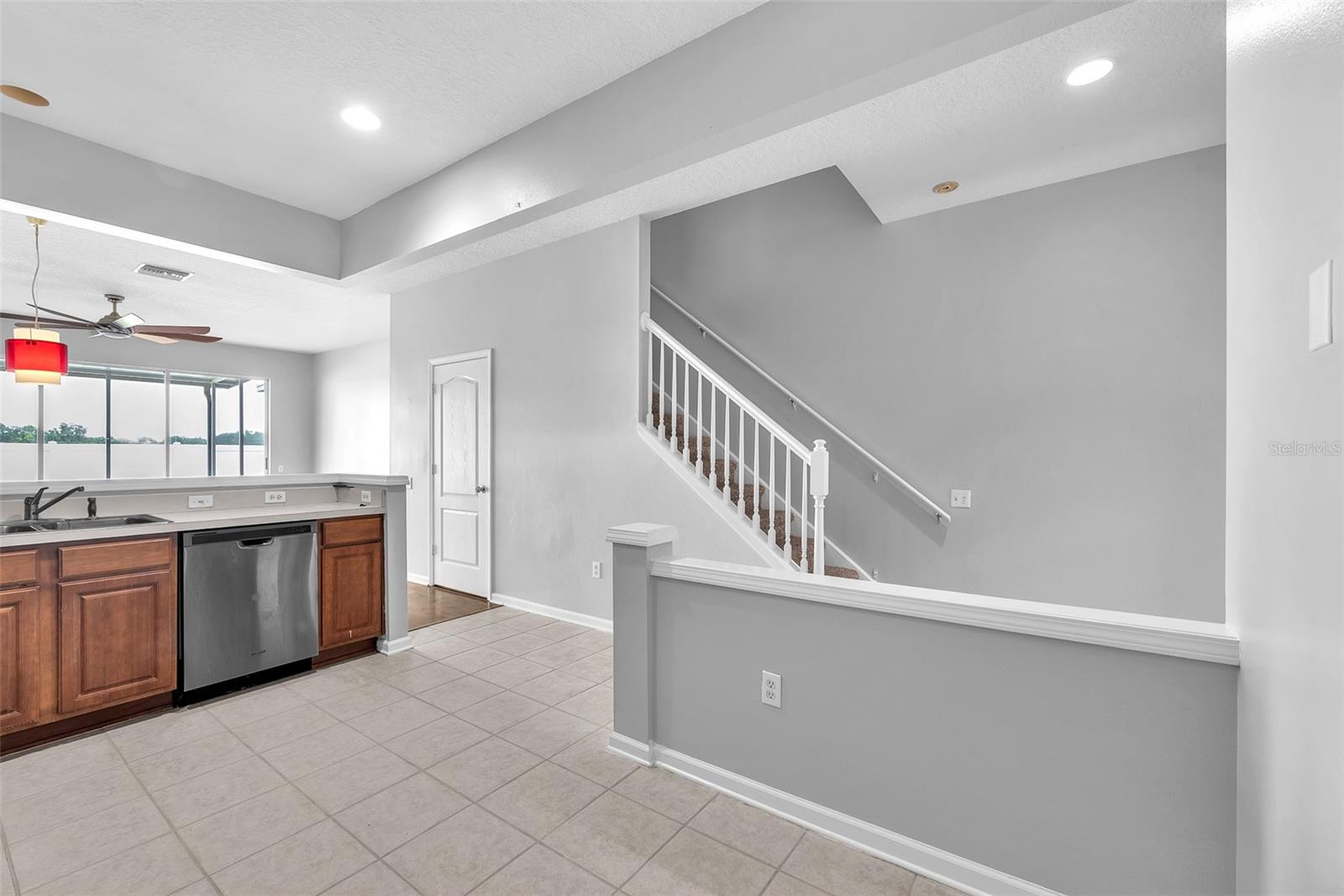 The kitchen opens seamlessly into the Living room/Dining room area and has sight-lines to the backyard and water view beyond.