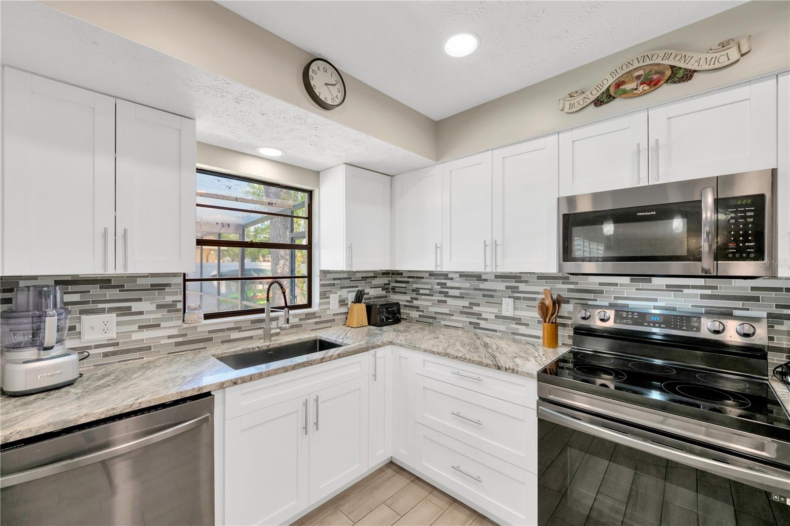 Kitchen has plenty of cabinets and drawer storage.