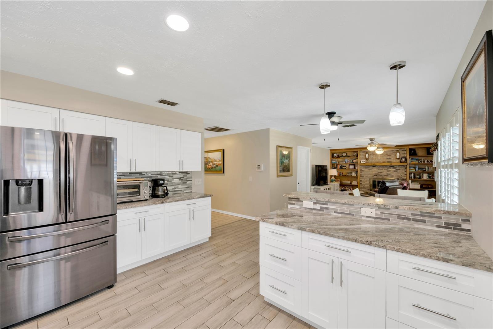 The breakfast bar and counter next to the refrigerator provide extra counter prep space.
